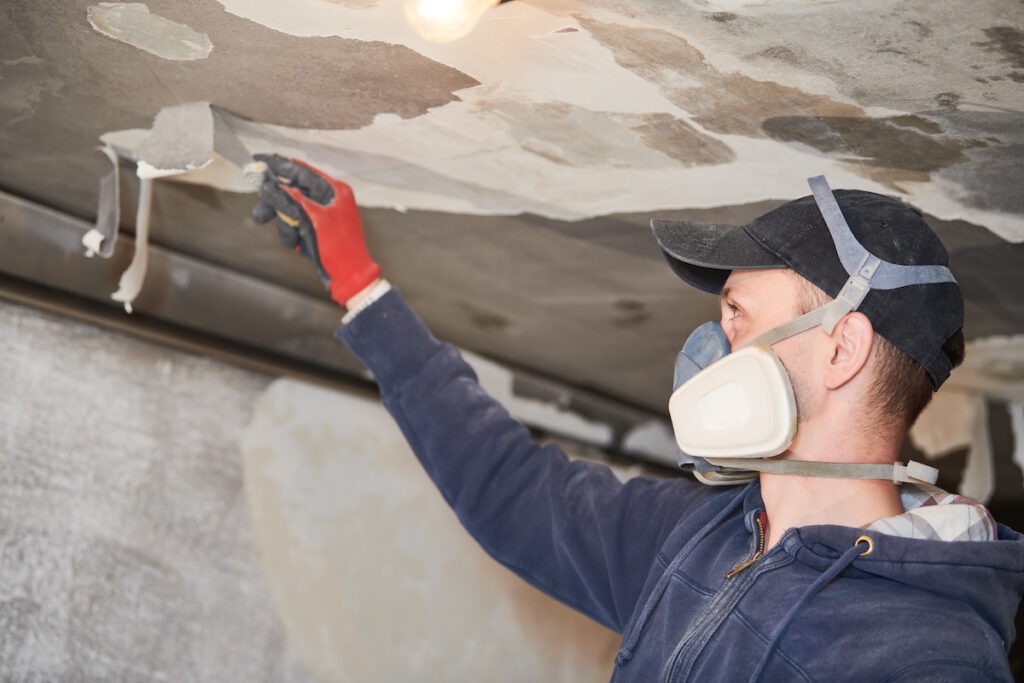 Technician restoring ceiling.